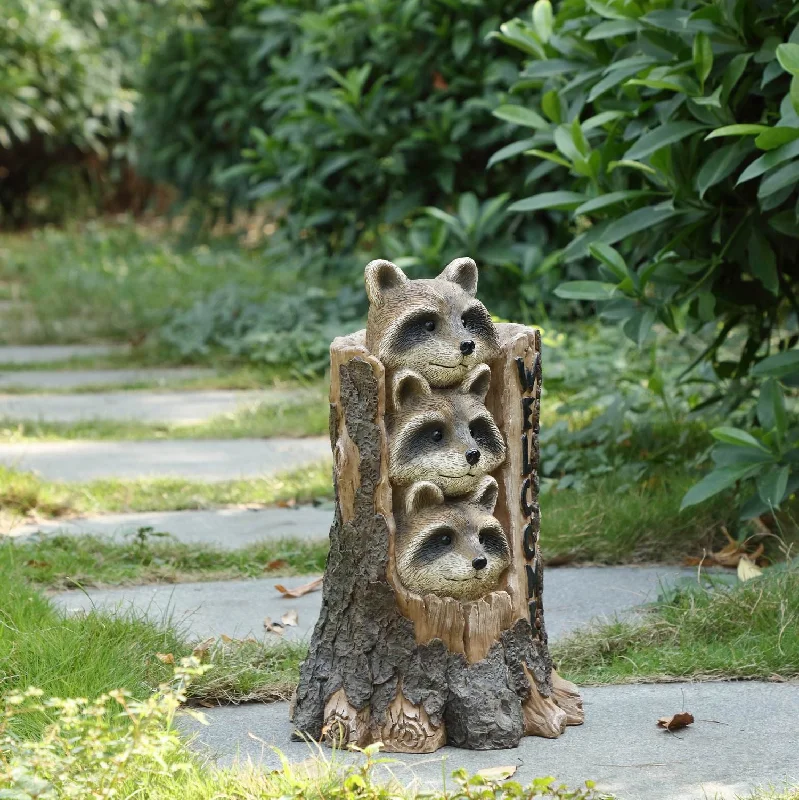 Racoon Stacking By Tree Trunk With Welcome Sign Statue