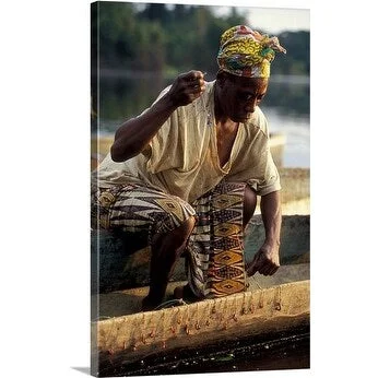 Premium Thick-Wrap Canvas entitled Woman in a pirogue on the Ivindo River prepares for a day of fishing. Gabon